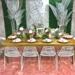 Black metal palm leaf floor sculpture with multiple leaves, modern tropical event décor accent.