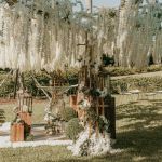 Black metal wire tree centerpiece stand with branching arms, used for hanging décor or floral displays.