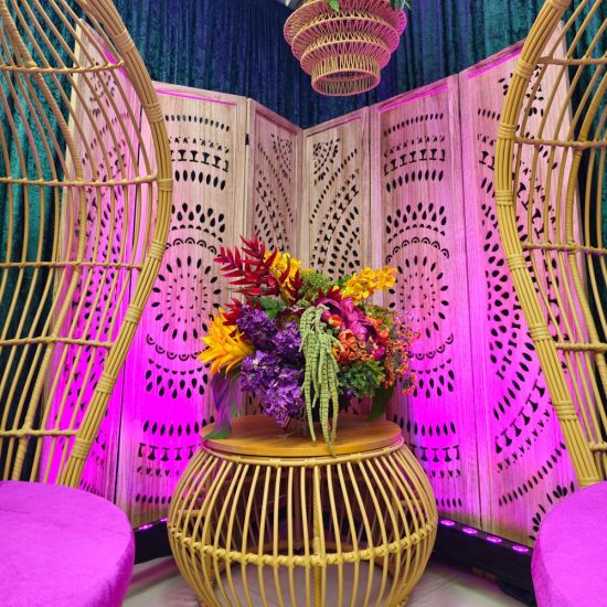 Natural wood folding room divider with ornate cutout pattern panels, decorative room screen for weddings, backdrops, and lounge décor.