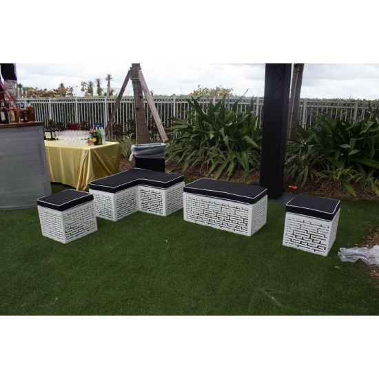 L-shaped Maze bench with black cushioned top and white geometric base, modern modular lounge seating for weddings and events.