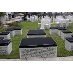 L-shaped Maze bench with black cushioned top and white geometric base, modern modular lounge seating for weddings and events.