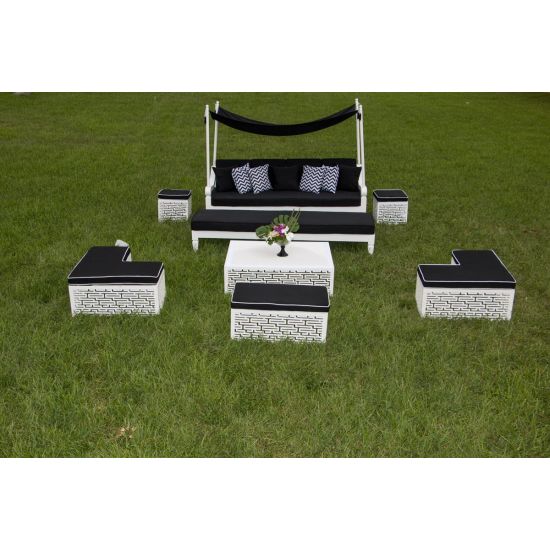 L-shaped Maze bench with black cushioned top and white geometric base, modern modular lounge seating for weddings and events.