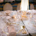 Clear crystal charger plate with thin black rim and smooth glass center, sleek modern charger for weddings and formal event tables