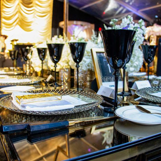 Clear harlequin charger plate with intricate radial geometric texture and transparent glass finish, modern charger for formal events