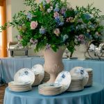 Lenox Garden Grove charger plate with white center, blue floral border accent, and thin gold rim, large round plate on a white background