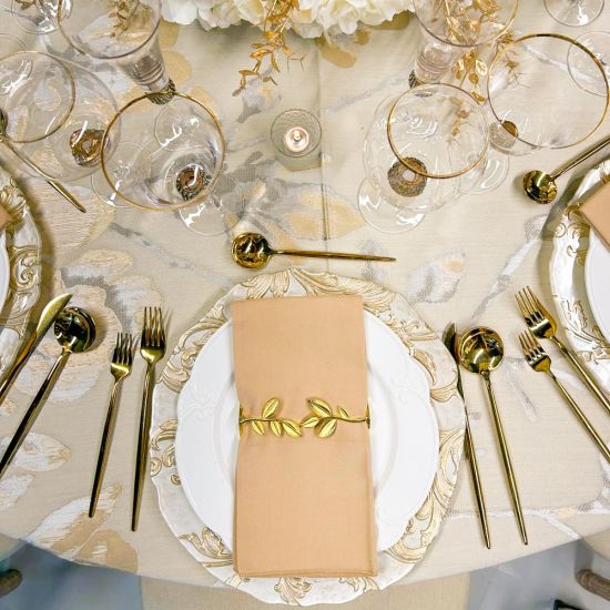 Ivy napkin holder with green faux ivy vine entwined around a metal ring holding a folded white cloth napkin, botanical accent for event tables