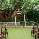 Gold hexagon arch backdrop frame with geometric shape and base supports, modern wedding ceremony arch for events and photo ops.