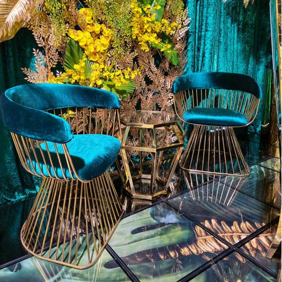 Gold stainless-steel Gem-frame end table with diamond-inspired geometry and glass top, ideal for luxury modern event lounge décor