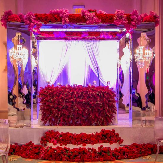 Tall gold mirrored neo-baroque column with ornate reflective panel design, luxury event decor pedestal for weddings and displays.