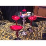 Black scoop-seat adjustable metal bar stool with chrome base and foot-rail, sleek contemporary event bar seating solution