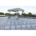 “Clear resin armless ghost chair with high oval backrest and transparent sleek frame, modern event guest seating”