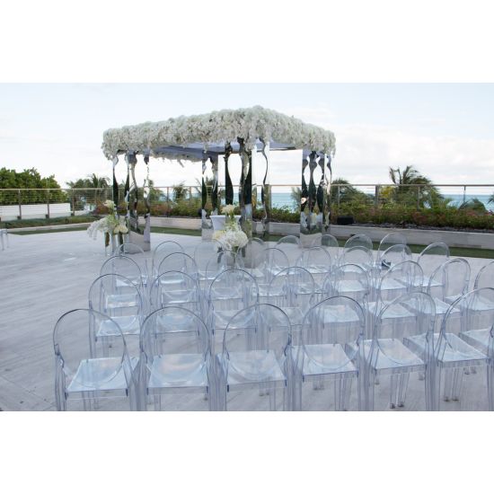 “Clear resin armless ghost chair with high oval backrest and transparent sleek frame, modern event guest seating”