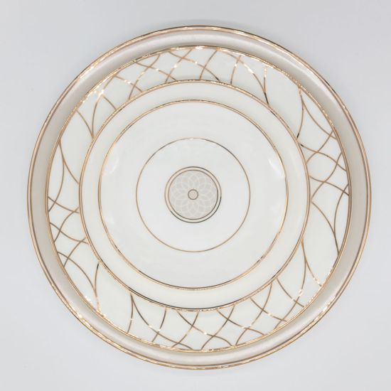 White dinner plate with thin gold rim and geometric gold line pattern around the edge, large round plate on a white background