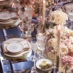 White dinner plate with thin gold rim and geometric gold line pattern around the edge, large round plate on a white background