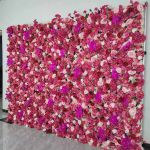 Bright fuchsia flower wall backdrop with dense mixed blooms, bold romantic photo backdrop panel for weddings and event décor styling.
