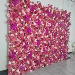 Bright fuchsia flower wall backdrop with dense mixed blooms, bold romantic photo backdrop panel for weddings and event décor styling.