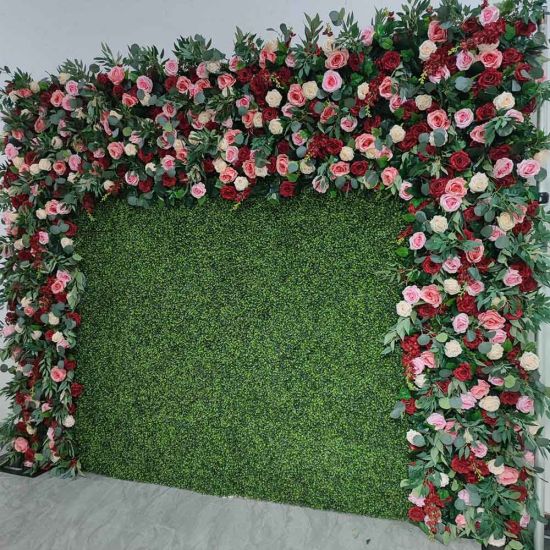 Green hedge wall with floral border frame of pink and white blooms, garden-style backdrop panel for weddings and photo booth setups.