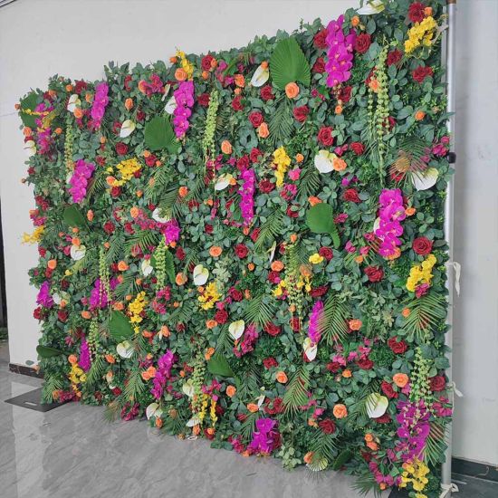 Green foliage wall backdrop with bright mixed flowers and tropical accents, colorful photo backdrop panel for parties and event décor.
