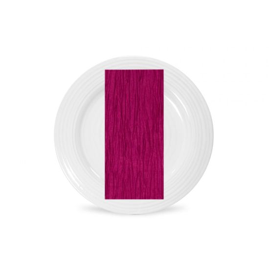 New fuchsia Fortuny napkin with pleated fabric texture and bright pink tone, folded on a white plate for festive event tables