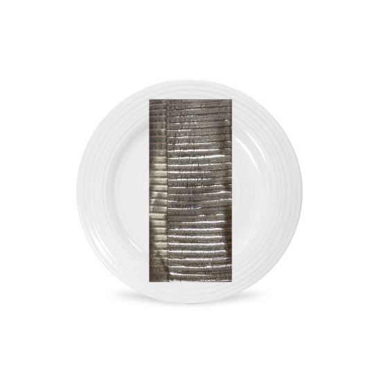 Silver grid-pattern napkin with metallic textured lines folded on a white plate, sleek modern accent for wedding and event table settings