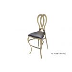 Gold Halexandria bar stool with Black cushioned seat and curved metal backrest on bar-height frame with foot-rail