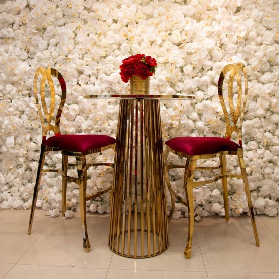 Gold Halexandria bar stool with Hot Pink cushioned seat and curved metal backrest on bar-height frame with foot-rail
