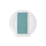 Aqua table napkin with white lace trim detail, neatly folded on a white plate for elegant weddings and formal event table settings