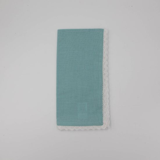 Aqua table napkin with white lace trim detail, neatly folded on a white plate for elegant weddings and formal event table settings