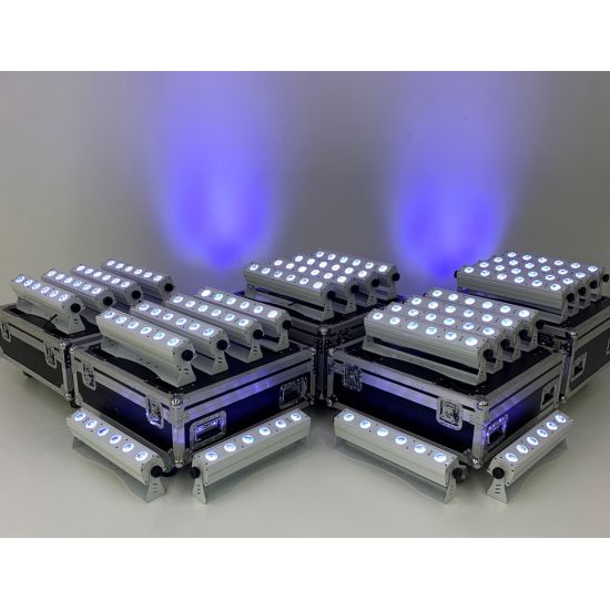 Group of battery-powered LED uplight bars on road cases with purple wash, wireless lighting package for weddings and event staging.