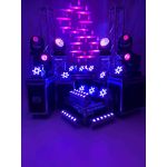 Uplighting setup with truss towers, moving lights, and LED fixtures on road cases, event stage lighting package for weddings and dance floors.