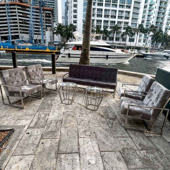 Eggplant velvet lounge armchair with polished silver frame and open square base, modern luxury seating for upscale event lounges.