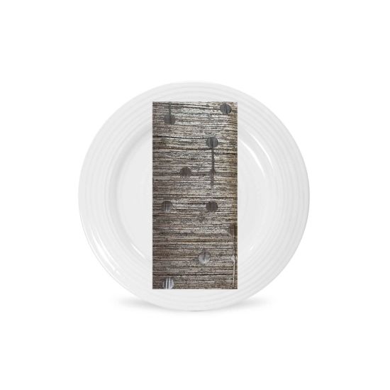 Silver morse napkin with textured metallic weave and subtle dot accents folded on a white plate, sleek modern accent for weddings and events
