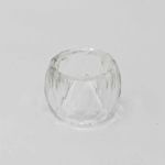 Large crystal cut napkin ring with faceted clear design holding a folded white cloth napkin, glamorous table accessory for wedding and formal event place settings