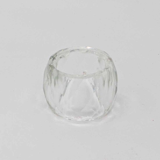 Large crystal cut napkin ring with faceted clear design holding a folded white cloth napkin, glamorous table accessory for wedding and formal event place settings