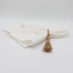 Natural wooden napkin ring with smooth grain texture holding a folded white cloth napkin, rustic table accessory for weddings and events
