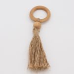 Natural wooden napkin ring with smooth grain texture holding a folded white cloth napkin, rustic table accessory for weddings and events