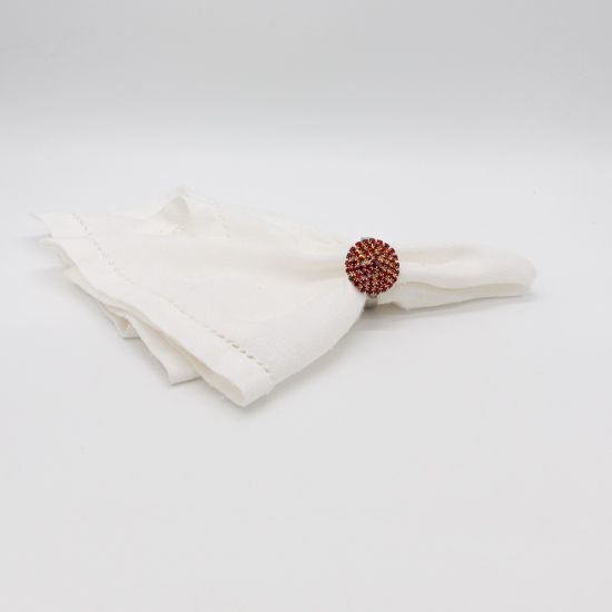 Red stone napkin ring with metallic band and faceted red gemstone detail securing a folded white cloth napkin, elegant accent for event tables
