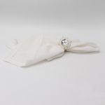Silver rose napkin ring with detailed floral metal design securing a folded white cloth napkin, elegant decorative accent for weddings and events