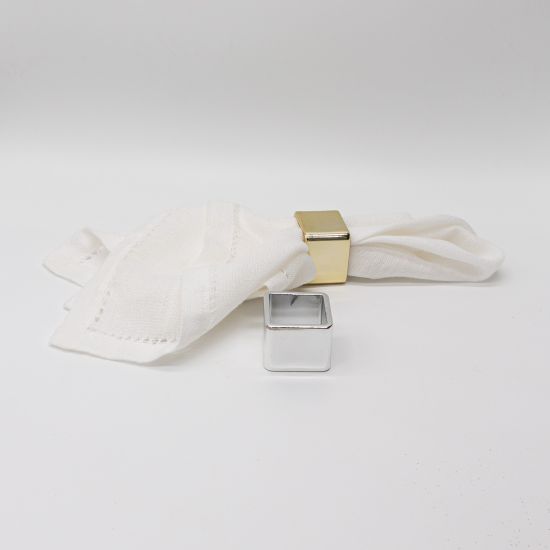 Square napkin ring with clean geometric frame securing a folded white cloth napkin, modern table accessory for weddings and formal events