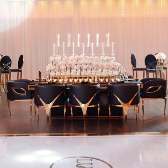 Gold trident accent armchair with smooth upholstery, curved back, gold-trim side cutouts, and sleek gold metal legs for luxury event lounge seating.