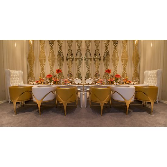 Gold trident accent armchair with smooth upholstery, curved back, gold-trim side cutouts, and sleek gold metal legs for luxury event lounge seating.