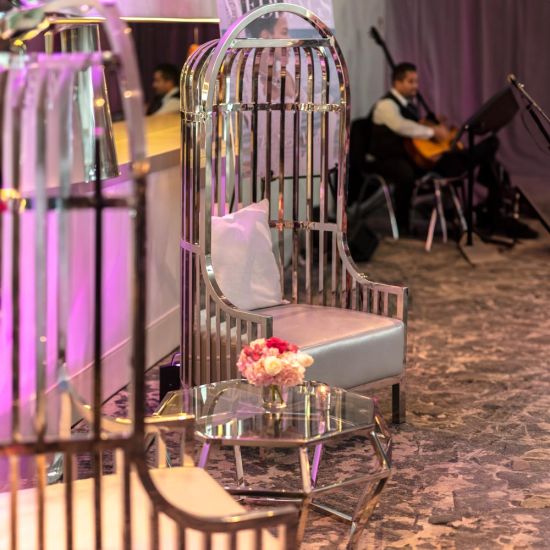 Gold dome cage armchair with vertical gold bars and eggplant velvet seat cushion, modern luxury lounge chair for weddings and events.
