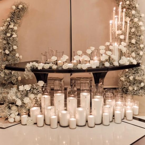 Reflection Serpentine black table with curved black top and black legs, modern serpentine dining table design for luxury event rentals and décor.