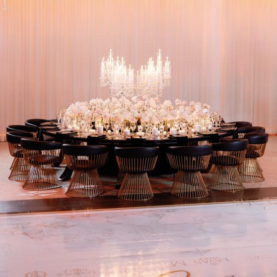 Reflection Serpentine black table with curved black top and black legs, modern serpentine dining table design for luxury event rentals and décor.