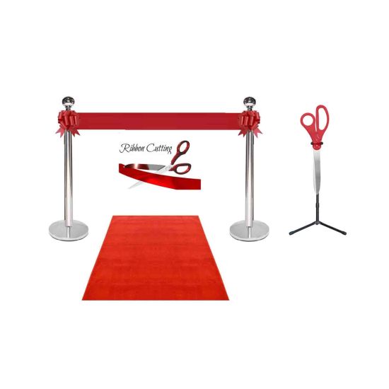Silver stanchion ribbon cutting set with red carpet runner, red ribbon, oversized ceremonial scissors on stand for grand opening events.