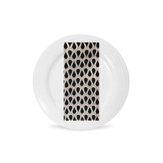 Chia taza napkin with repeating teardrop pattern in black and white tones, folded on a white plate for modern wedding table décor